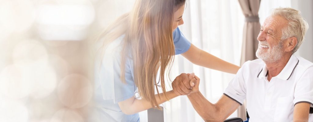 Web banner Man being cared for by a private Asian nurse at home suffering from Alzheimer's disease to closely care for elderly patients with copy space on left